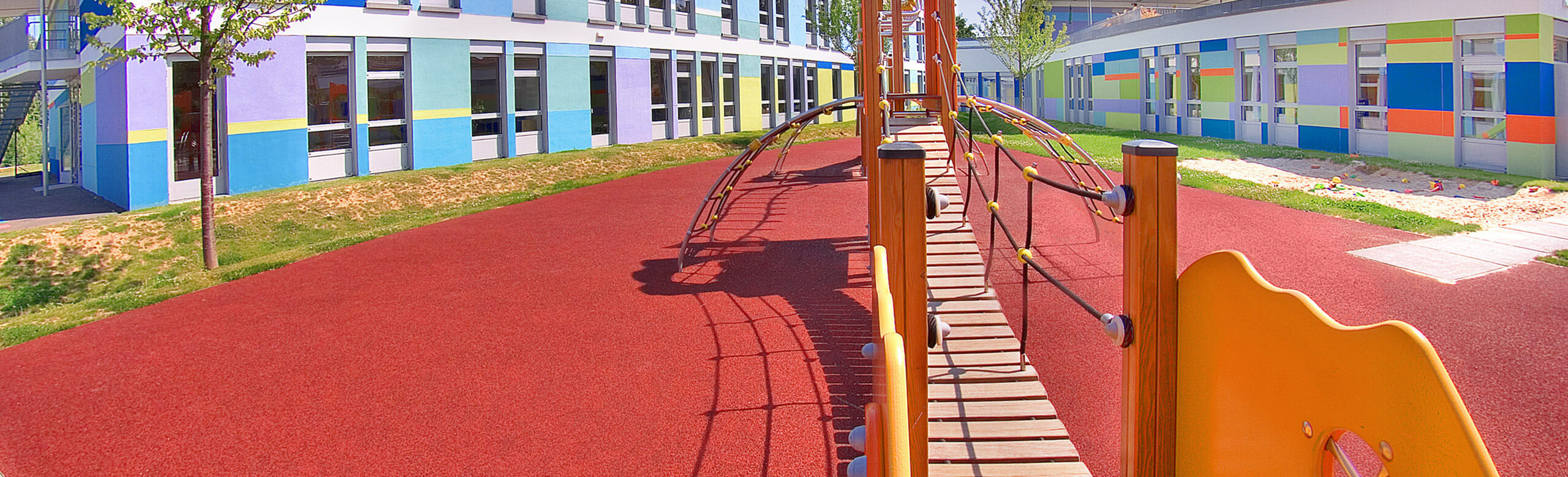 Playground with a red safety flooring from REGUPOL