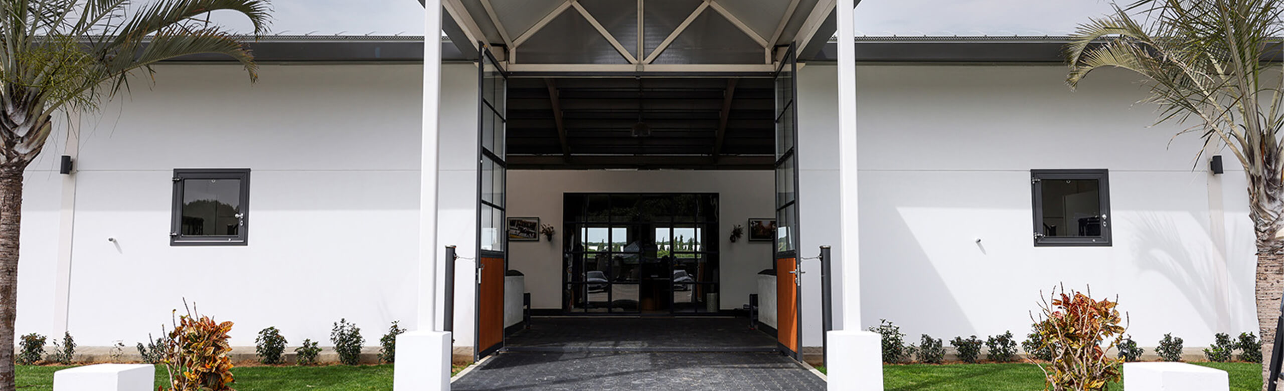 Modern equestrian facility with covered stable aisle and high-quality REGUPOL equestrian flooring – durable, slip-resistant flooring for horse stables and equestrian centers